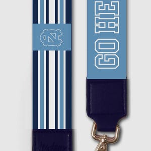 May include: Two blue and white patterned straps with navy blue leather ends and silver clasps. One strap features the text "GO HEELS" in white, while the other displays the UNC logo and vertical stripes.
