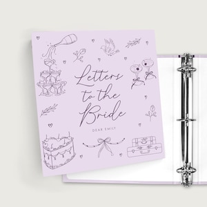 May include: A light purple three-ring binder with the text Letters to the Bride and DEAR EMILY printed on the front cover. The cover features dark purple line art illustrations of a champagne tower, a cake, suitcases, a bow, and small hearts.