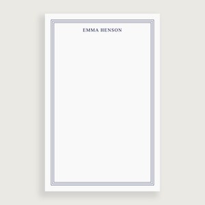 May include: A white stationery card with a blue border and the name "Emma Henson" printed at the top.