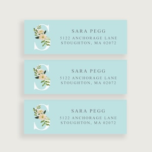 May include: Three light blue return address labels with a white floral design and the text "SARA PEGG" followed by the address "5122 ANCHORAGE LANE STOUGHTON, MA 02072".