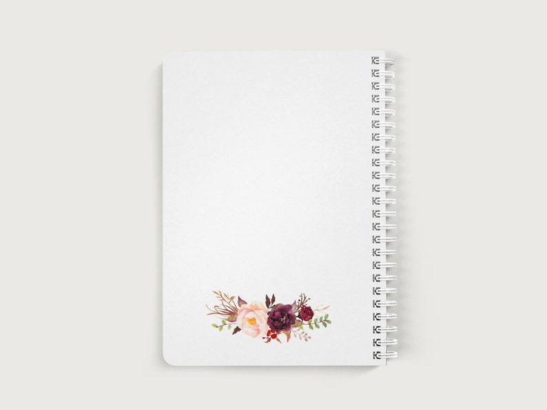 May include: A white spiral bound notebook with a floral design on the bottom right corner. The flowers are pink, red, and burgundy.