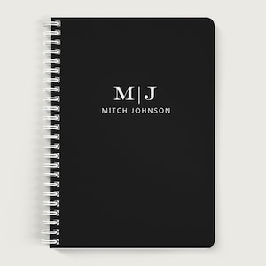 May include: Black spiral bound notebook with white text that reads "M|J Mitch Johnson".