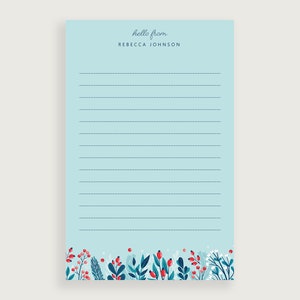 May include: A light blue notepad with a floral border and the text "hello from REBECCA JOHNSON" at the top. The notepad has lined paper for writing.