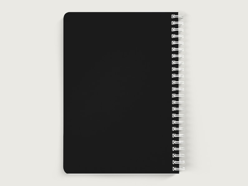 May include: A black spiral bound notebook with a blank cover.