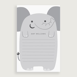 May include: A gray elephant illustration with a smiling face and a line for writing. The text "AMY WILLIAMS" is written below the elephant.