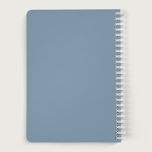 May include: A blue spiral bound notebook with a plain cover.