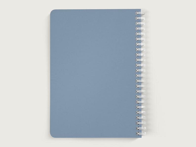 May include: A blue spiral bound notebook with a plain cover.