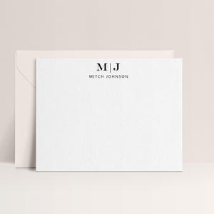 May include: White stationery set featuring a personalized design. The card displays the initials "M | J" above the name "Mitch Johnson" in a minimalist, sans-serif font. An envelope is visible behind the card.