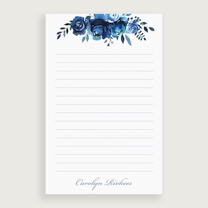 May include: Blue floral notepad with lined paper and the name "Carolyn Rivkees" printed at the bottom.