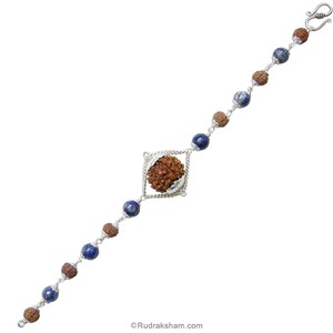 May include: A silver bracelet with blue and brown beads. The center bead is a brown rudraksha bead in a silver square frame.