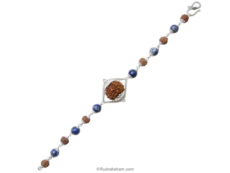 May include: A silver bracelet with blue and brown beads. The center bead is a brown rudraksha bead in a silver square frame.