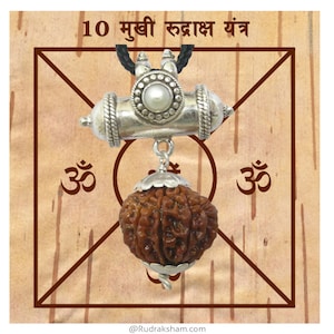 May include: A silver pendant with a 10-faced Rudraksha bead and a silver Om symbol. The pendant is hanging from a black cord and is set against a brown background with the text "10 मुखी रुद्राक्ष यंत्र".