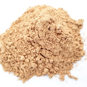 May include: A pile of light brown powder, likely a spice or ingredient for cooking or baking.