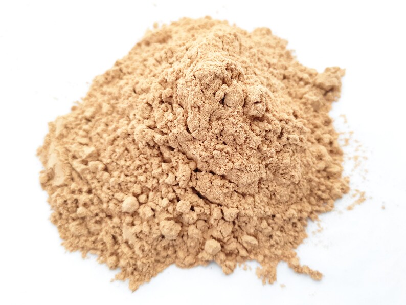 May include: A pile of light brown powder, likely a spice or ingredient for cooking or baking.