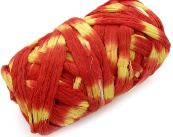 May include: A close-up of a red and yellow yarn ball. The yarn is woven together in a tight, intricate pattern.