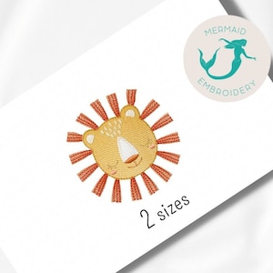 May include: Embroidered lion face design with a yellow face and orange mane. The design is available in two sizes. The text "Mermaid Embroidery" is in the top right corner of the image.