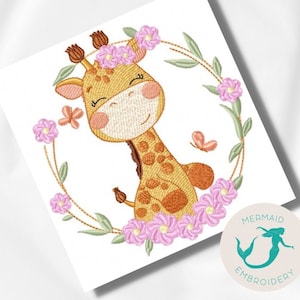 May include: Embroidered design of a cute giraffe with pink flowers and butterflies. The giraffe is smiling and has a brown and yellow spotted pattern. The design is surrounded by a green wreath.