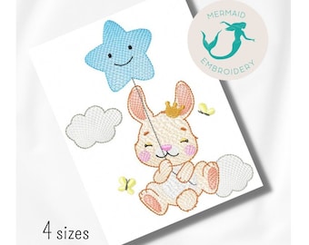 May include: Embroidered design of a cute bunny holding a blue star balloon. The bunny is wearing a crown and has pink cheeks. There are clouds and butterflies in the background. The design is available in 4 sizes.