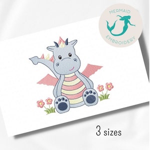 May include: A blue and pink cartoon dragon with a crown sits on a green patch of grass with pink flowers. The dragon has a striped body and blue feet.