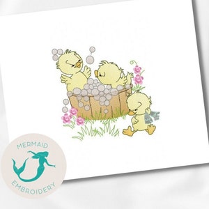 May include: Three yellow chicks in a wooden tub with bubbles. One chick is outside the tub and walking towards the tub. The chicks are surrounded by green grass and pink flowers.