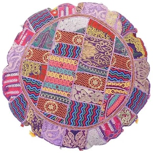 May include: A round, purple and multi-colored patchwork floor cushion with a circular design. The cushion is made of fabric scraps sewn together in a patchwork pattern.