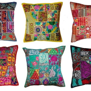 May include: Six colourful patchwork cushion covers with intricate embroidery and embellishments. The covers are made from a variety of fabrics in shades of red, blue, green, yellow, and purple.