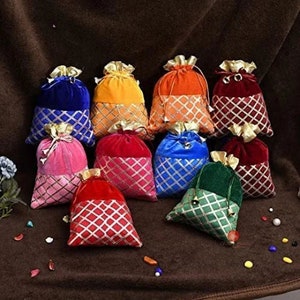 May include: Assortment of ten small drawstring bags in various colors, including red, blue, green, pink, orange, and yellow. Each bag has a contrasting color trim and a gold drawstring.