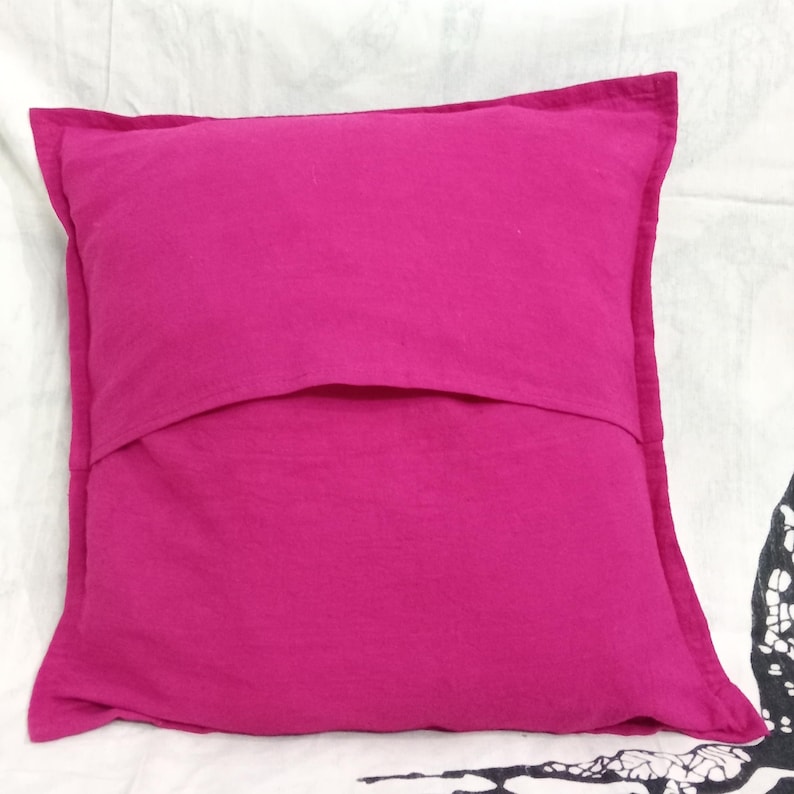 May include: A bright pink pillow with a hidden zipper closure on the back. The pillow is made of a soft, cotton fabric.