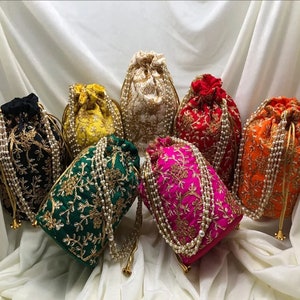 May include: Seven drawstring bags with pearl embellishments. The bags are in various colors, including black, green, yellow, white, red, pink, and orange. Each bag has a gold embroidered design.