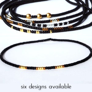 May include: Black waist beads with gold and silver accents. Six designs are available.
