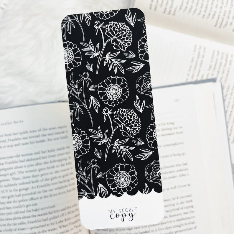 May include: Black and white bookmark with a floral pattern and the text "MY SECRET COPY" at the bottom.