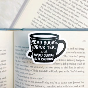 May include: Black and white sticker of a teacup with the text "Read Books, Drink Tea, and Avoid Social Interaction".