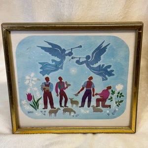 May include: A framed painting featuring two blue angels blowing trumpets in a light blue sky above four figures and several sheep. The figures are dressed in red, purple, and green clothing. A single bright star shines between the angels.