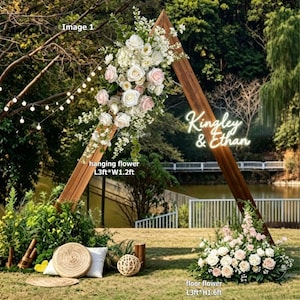 May include: A triangular wooden wedding arch featuring a large floral arrangement of white and pale pink roses with greenery, a neon sign reading Kingley & Ethan, and a floor floral display. Hanging flower measures 3ft by 1.2ft, floor flower 3ft by 1.6ft.