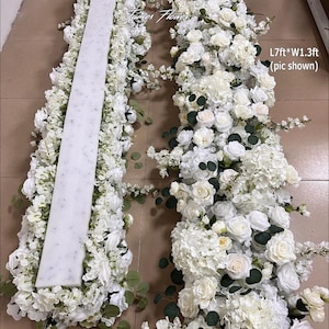 May include: Two floral arrangements with white roses, hydrangeas, and foliage. One has a central white panel. The text "James Flower" is visible. The dimensions are approximately 213cm long and 40cm wide.