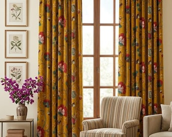 May include: A pair of floor-length mustard yellow curtains featuring a repeating floral pattern in red, green, and white. The curtains hang from a dark metal rod and frame a window with a wooden frame, positioned behind a striped armchair.