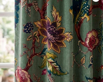 May include: A sage green curtain featuring a dense botanical print with large, multi-colored flowers in shades of deep purple, magenta, yellow, and dark blue. The fabric displays intricate branches and leaves, with the text designed by PUREPRINTS.