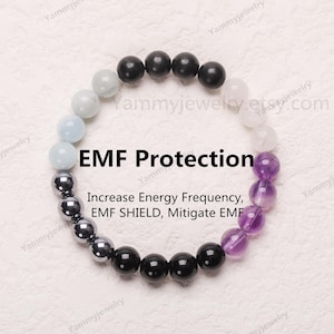 May include: A bracelet made of amethyst, black, and grey beads. The bracelet is designed to protect against EMF radiation. The text on the image reads "EMF Protection Increase Energy Frequency, EMF SHIELD, Mitigate EMF".
