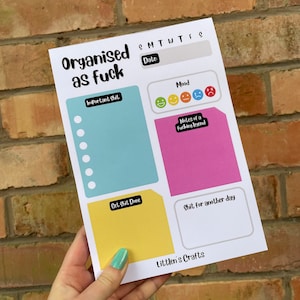 May include: A printable daily planner with the text "Organised as fuck" at the top. The planner includes sections for important tasks, mood tracking, notes, and tasks to be completed later. The planner is designed with a colourful and playful aesthetic.