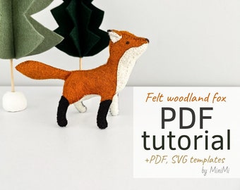 May include: Felt woodland fox PDF tutorial with PDF and SVG templates by MiniMi. The image shows a brown fox with a white chest and black legs standing in front of two green felt trees.