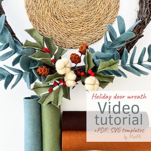 May include: A felt holiday door wreath with green and blue leaves, red berries, white cotton balls, and brown pinecones. The wreath is on a brown twig base. The image also shows rolls of felt in green, blue, brown, and orange. The text on the image reads "Holiday door wreath Video tutorial +PDF, SVG templates by MiniMi".