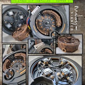 May include: Close-up of a copper-coloured cyclotron kit with a black and silver casing. The kit is installed and features a circular design with multiple coils and wires. The kit is labelled "Cyclotron Kit Installed - Copper Kit" and "Mossy Sign Co."