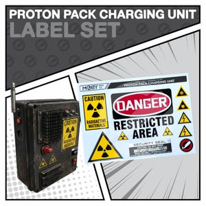 May include: A black and grey Proton Pack Charging Unit with a label set. The label set includes "Danger" and "Caution" signs with radiation symbols. The unit has a red knob and antenna.