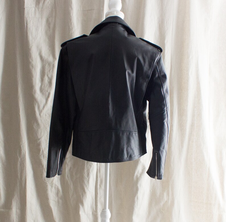 May include: Black leather jacket with a zipper closure and a stand-up collar.
