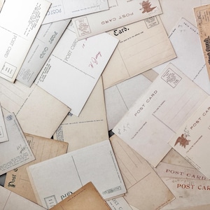 May include: A collection of vintage postcards, some with handwritten notes and stamps. The cards vary in color from cream to tan, with the words "Post Card" printed on many. Some cards have an eagle illustration.
