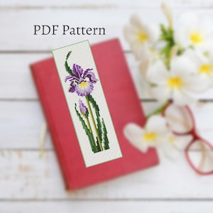 May include: A PDF pattern for a beaded bookmark featuring a purple iris flower with green leaves on a white background. The text "PDF Pattern" is at the top of the image.
