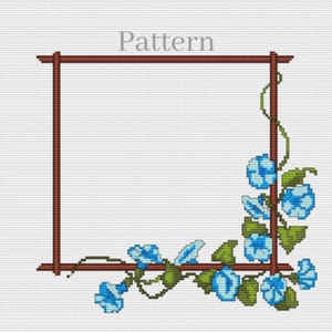 May include: Cross-stitch pattern featuring a brown square frame with blue floral accents. The flowers and leaves are in shades of blue and green, with the word "Pattern" at the top.
