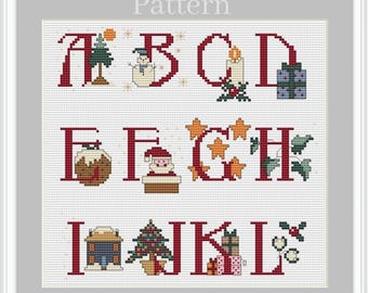 May include: A cross-stitch pattern featuring the letters A through L with Christmas-themed illustrations. The letters are red, and the illustrations include a snowman, a candle, a Christmas tree, a stocking, Santa Claus, a star, a house, and a gift.