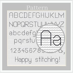 May include: A cross stitch pattern featuring the alphabet, numbers, and the phrase "Happy stitching!" in black on a white background.