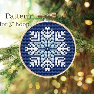 May include: A blue and white snowflake cross-stitch pattern for a 3-inch embroidery hoop.